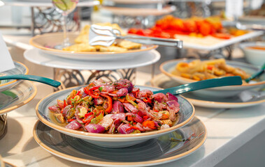 Onion salad with vegetables on the table.