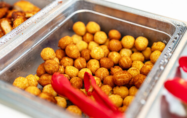 Fried cheese balls in a metal container.