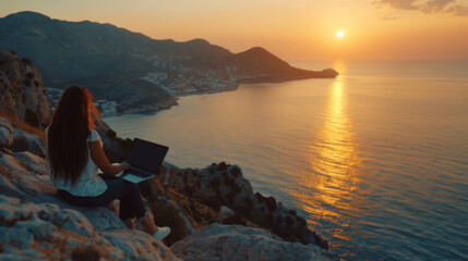 Woman Working on Laptop During Sunset on Rocky Cliff