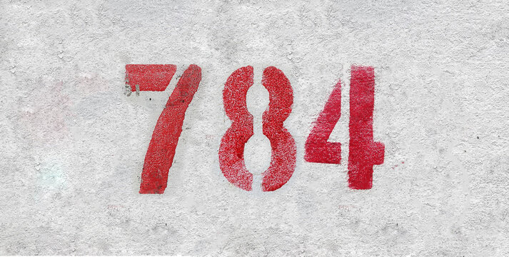 Red Number 784 on the white wall. Spray paint.