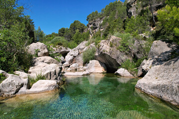 Small pool on Brugent river on sunny summer day. La Riba, Tarragona Province, Spain.
