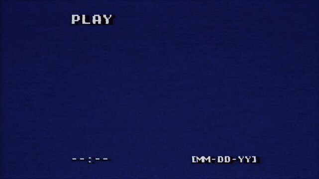 Retro video screen displaying PLAY text in pixelated white font against a deep blue background. Date placeholder MM-DD-YY and time indicator visible, evoking nostalgic gaming or VCR interface.
