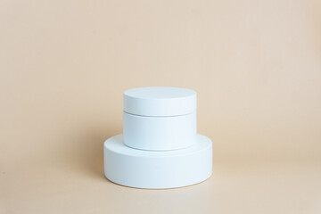 White podium on cream background color. Podium for displaying product presentation