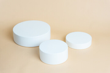 White podium on cream background color. Podium for displaying product presentation