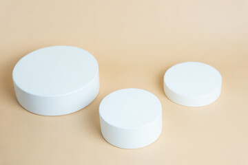 White podium on cream background color. Podium for displaying product presentation