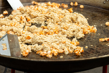Rice with shrimps on a huge frying pan seafood close-up street food