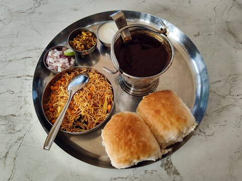 Authentic Maharashtrain spicy misal pav, Misal pav is a food of usal, sprouts curry, topped with onions, tomatoes, farsan.