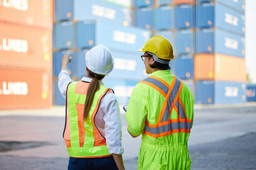 back view workers looking and pointing above in containers warehouse storage