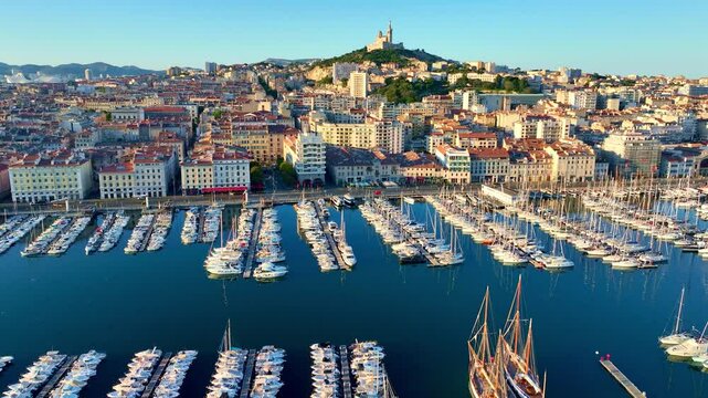 harbour and port of Marseille at sunrise, aerial shot of the capital of Provence, France, seaside town on French Riviera, drone view of Marseille at sunrise
