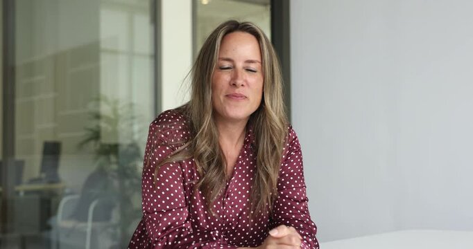 Positive Caucasian businesswoman speaking at camera, talking on video online conference call, enjoying remote job, Internet communication at office workplace table, smiling, laughing