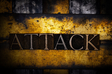 Attack text with on grunge textured copper and gold background 