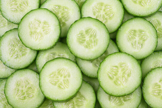 Cucumber background. Round cucumber slices, top view.