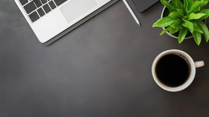 A laptop and a cup of coffee sit on a table