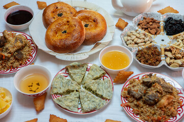 Meal with traditional Kyrgyz dishes served in the yurt. Local food in Kyrgyzstan.