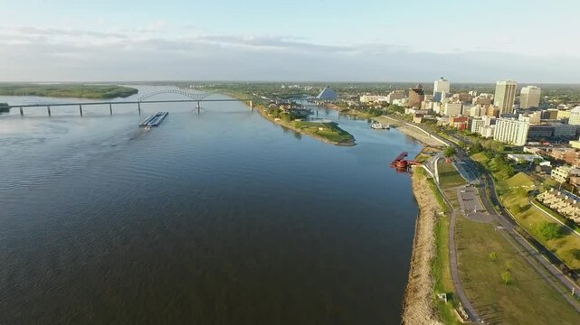 Memphis Cityscape in Tennessee.  Mississippi River Barge Hernando de Soto Bridge and Trafic in Background. Drone