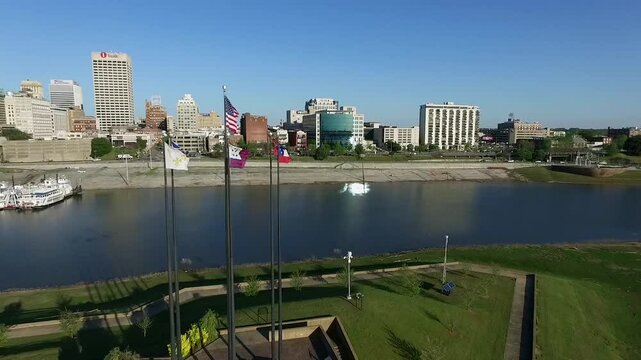 Waving Flags in Mud Island River Park, Memphis, Tennessee. Hernando de Soto Bridge and Mississippi River in Background. Drone