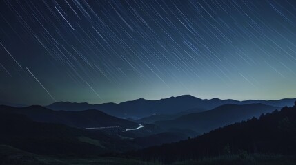Fototapeta premium Night Sky with Time-Lapse of Star Trails over Mountain Range