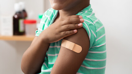 Vaccine and child with plaster on arm, medical shoulder injection dose and immunization bandage....