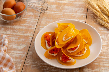 Thai crepes ,Thai Crispy Pancake topped with strips of egg yolks ,salt and sweet fillings(Kanom Buang).popular thai street food