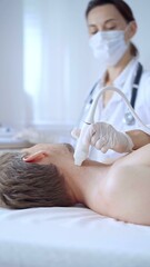 Fototapeta premium Doctor woman with white medical gloves performing neck ultrasound exam on male patient. Thyroid gland examination. Medicine concept