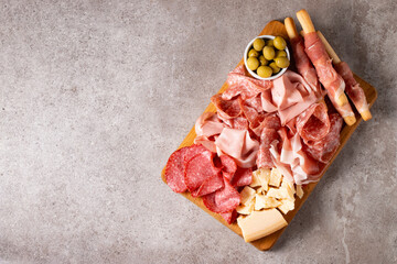 Charcuterie board. Antipasti appetizers of meat platter with salami, prosciutto crudo or jamon and olives.