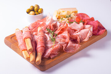 Charcuterie board. Antipasti appetizers of meat platter with salami, prosciutto crudo or jamon and olives.