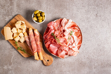 Charcuterie board. Antipasti appetizers of meat platter with salami, prosciutto crudo or jamon and olives.