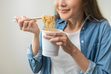 Happy temptation, attractive asian young student woman, cute girl using chopsticks eating instant...