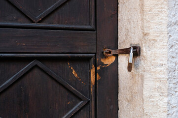Weathered wooden door with a padlock