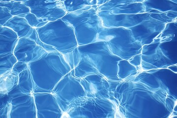 Abstract blue water texture with rippling surface and sunlight reflections.