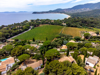 Aerial view on hills, houses and green vineyards Cotes de Provence, production of rose wine near...
