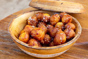 Luqaimat in a wooden plate in Dubai. The iconic Emirati traditional dessert.