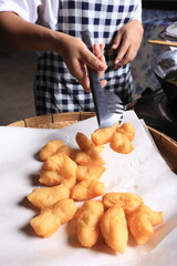 Hotel staff are frying Patongko dough sticks (sugar sponge cake) in boiling oil. Popular breakfast for Chinese people 
