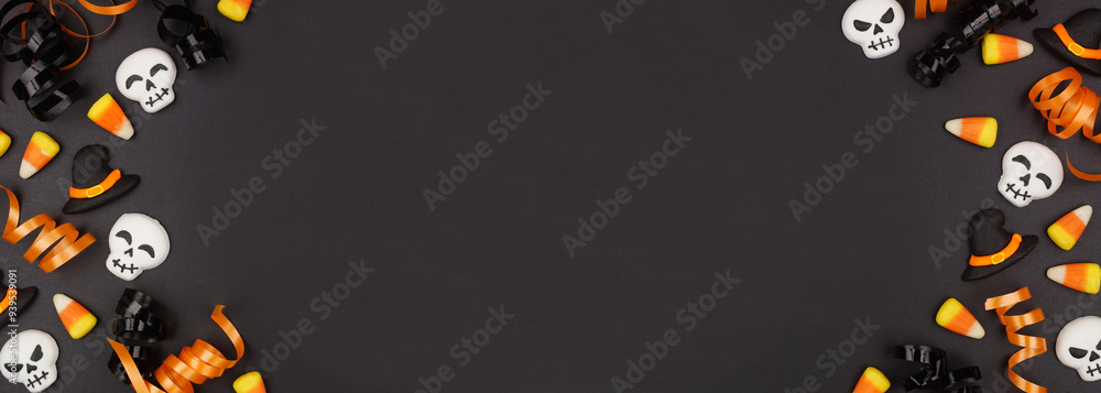 Poster halloween double border of black, white and orange color candy and ribbon. top view on a black banne