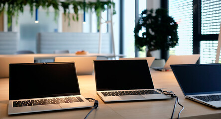 Laptops on a table in a co-working space