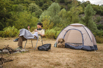 mature japanese woman with flask alcohol and on a camping trip