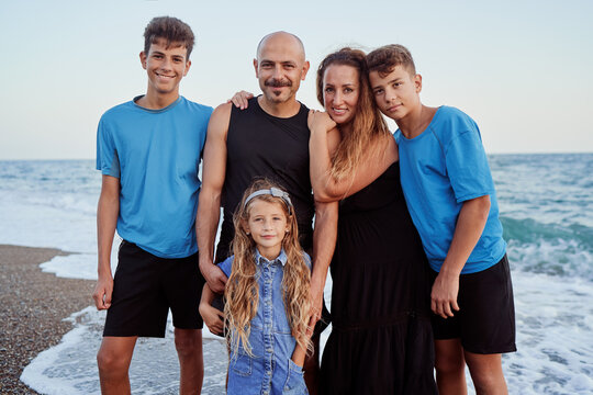 Outdoor portrait of joyful family on the seashore