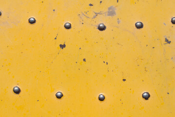 Top down view of yellow worn floor of merry-go-round with bolt details steampunk grunge background