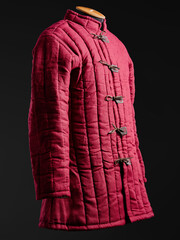 Historical fashion. Medieval knight cloth. Padded jacket gambeson.