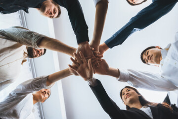Bottom view spiral round hand made by diverse office worker or business people join hand together...