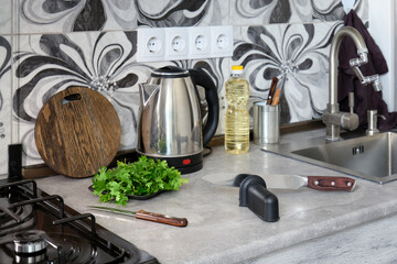 A special device for sharpening knives and a large kitchen knife on the table.