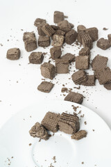 Biscuits chocolate with crumbs on white background. It is a chocolate cookies with a sweet cream.
