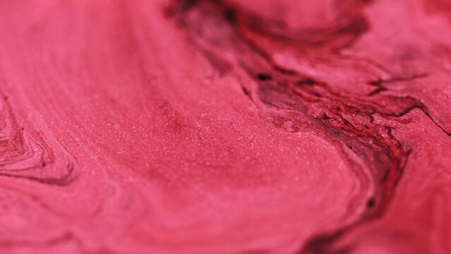 Ink emulsion. Glitter flow. Glowing texture crimson pink red black mix pigment sparking particles hypnotical abstract art background.