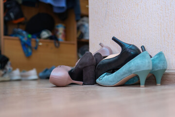 scattered array of elegant women's shoes sprawled on the floor, embodying a chaotic blend of style...
