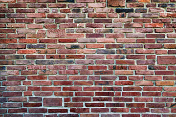 Rustic Red Brick Wall Texture. A detailed image of a rustic red brick wall showcasing various shades and textures.