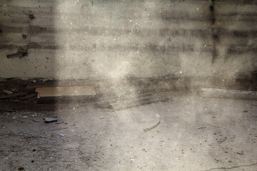 RaA beam of sunlight streams through the window, casting light onto the dust-filled air of an abandoned room. The scene captures the stillness and passage of time in forgotten places.