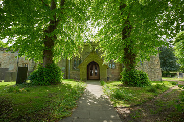 Shady path leading to a church door