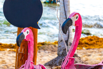 Pink flamingo decorative figure on the beach statue Mexico. © Arkadi