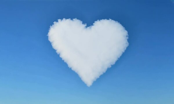 Heart shaped white cloud in a clear blue sky