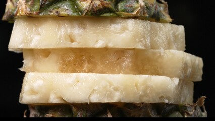 Close up video of fresh pineapple with slice of peel pineapple insert with separated black...